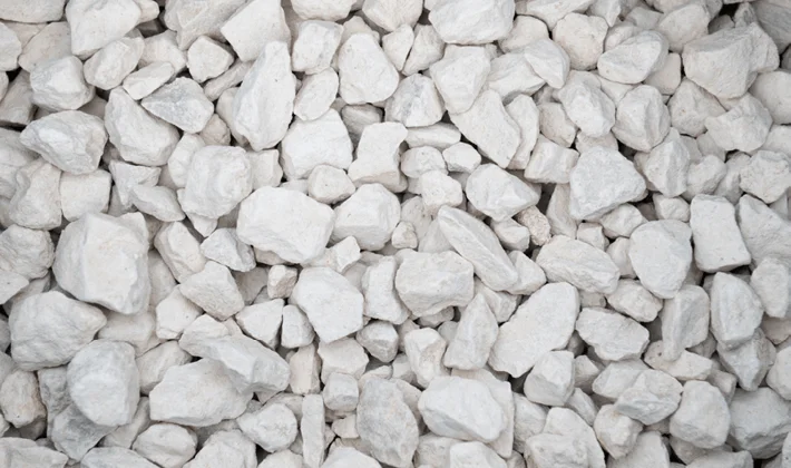 Buff-coloured clean limestone chippings displayed dry, containing grades from 10mm to 20mm.