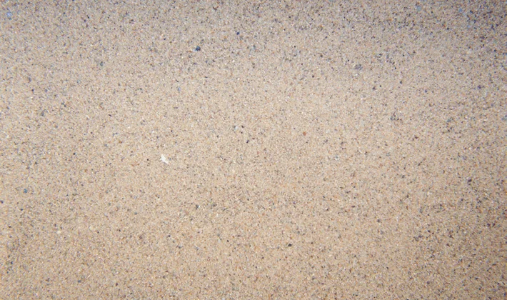 Loose display of sub-angular particles of kiln dried sand, varied colours.