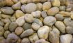 Loose display of rounded roofing shingle, graded from 20mm to 40mm, containing river-washed, multi-coloured pebbles, showcased in a dry condition.